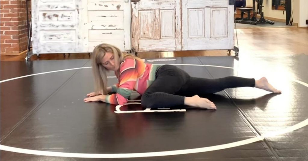 a woman performing a repetitive straing injury stretching exercise on the floor