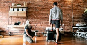 physical therapist JJ Thomas working with triathlete patient to resolve calf pain at Bryn Mawr Physical Therapy Clinic