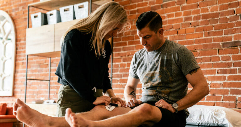 Physical therapist consulting with a patient during treatment