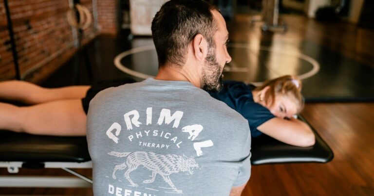 Physical therapist providing hands-on treatment to a patient