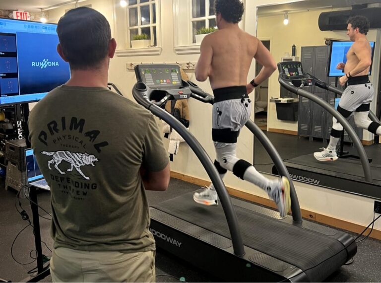 Physical therapist performing treadmill-based gait analysis