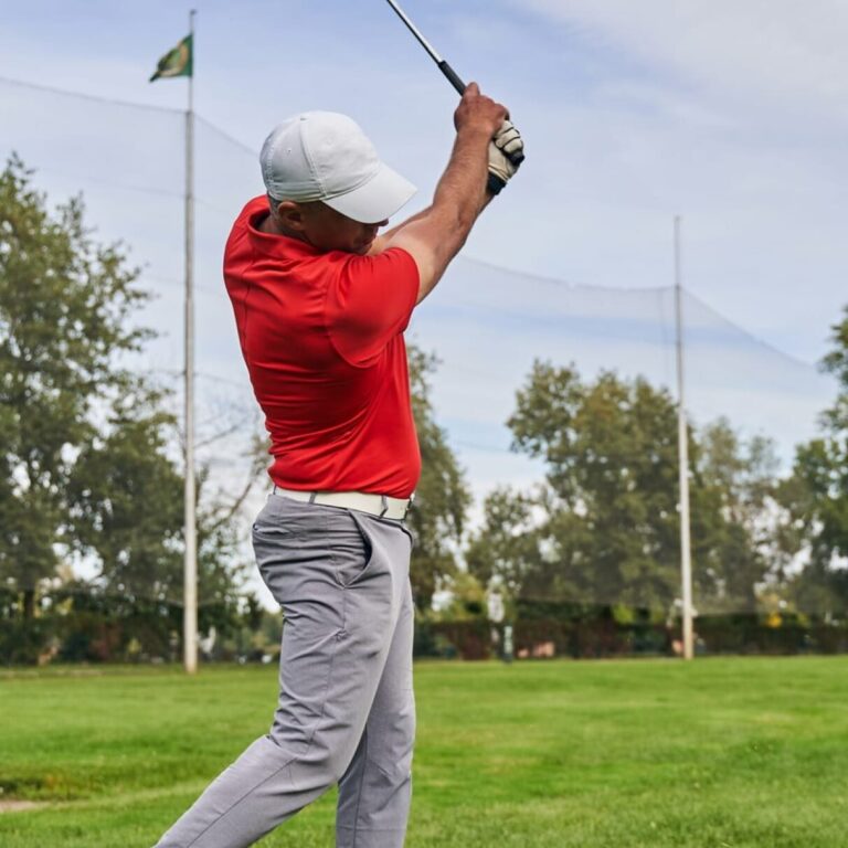 Physical therapist performing a biomechanical analysis of a patient's golf swing.