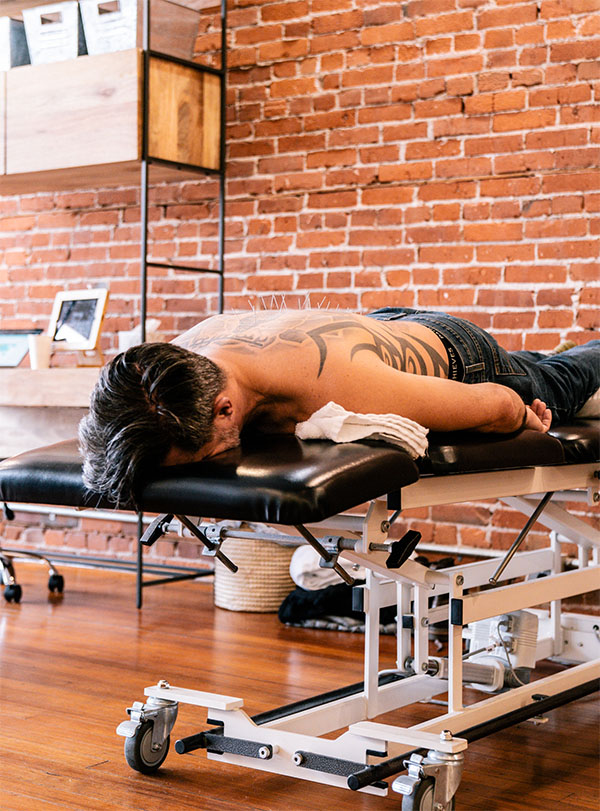 Patient receiving treatment for back pain at Primal Physical Therapy
