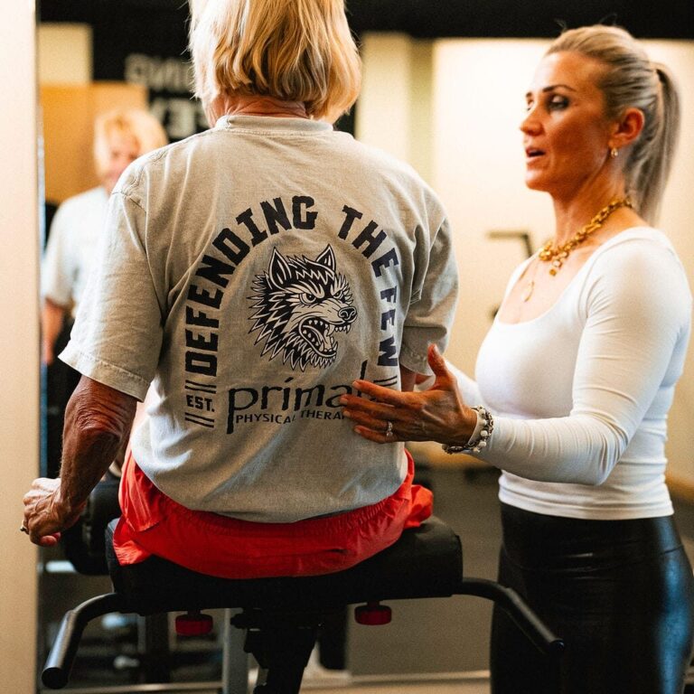 Physical therapist treating a patient suffering from debilitating back pain to improve mobility.