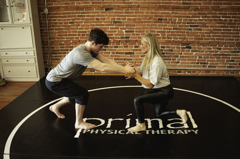 Physical therapist assisting an athlete in their recovery from a sports-related injury.