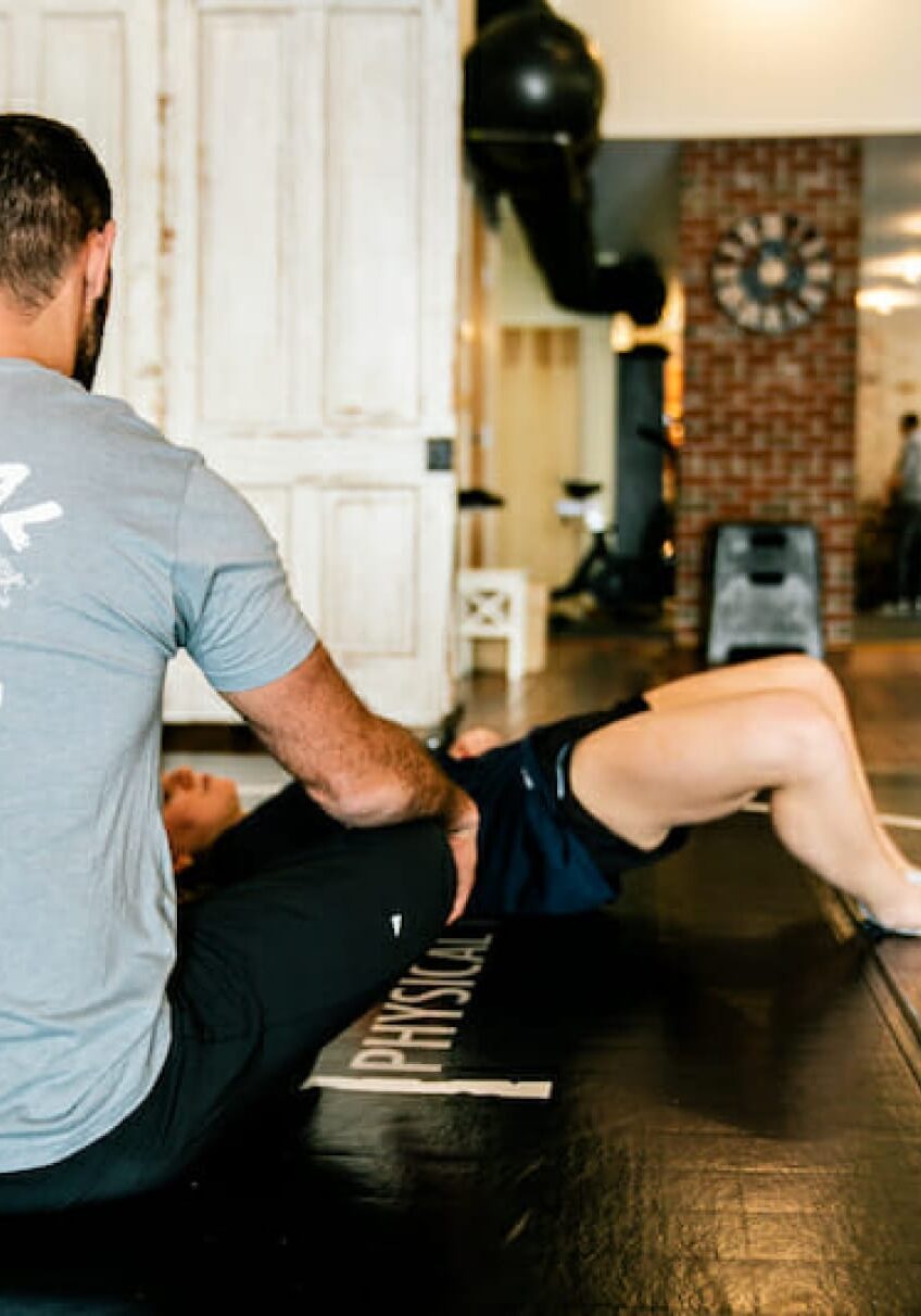 Dr. Eric Abramowitz providing specialized sports therapy to a client, focusing on targeted treatment techniques to enhance recovery and performance.