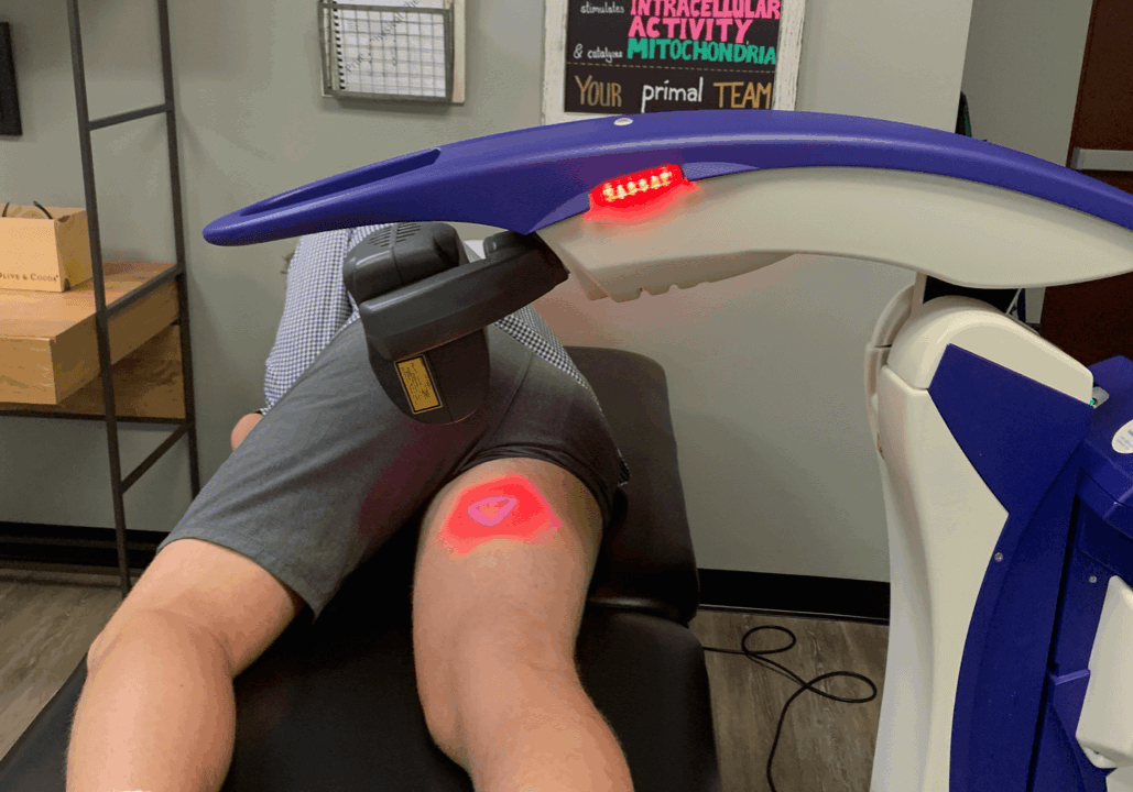 laser-therapy-machine man laying in laser therapy machine with laser on inner thigh