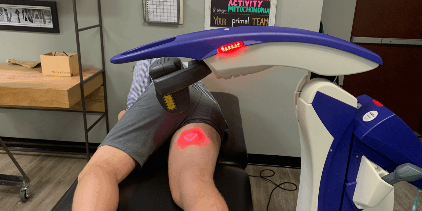 man laying in laser therapy machine with laser on inner thigh