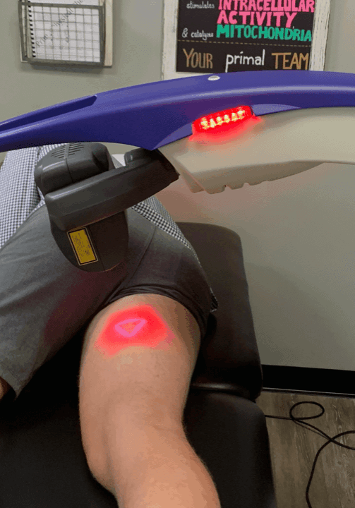 man laying in laser therapy machine with laser on inner thigh