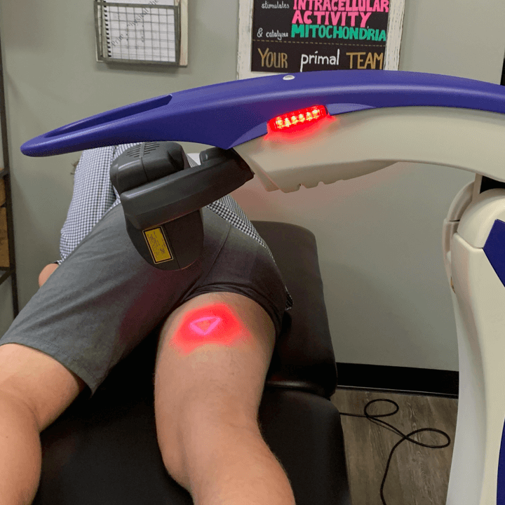 laser-therapy-machine man laying in laser therapy machine with laser on inner thigh