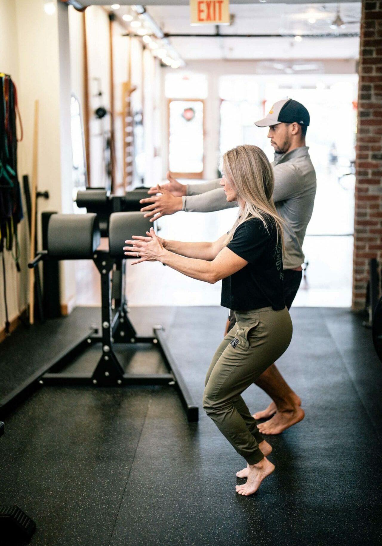 Man in a cap doing an exercise with a therapist
