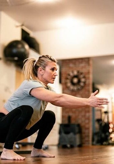 physical therapist performing squat exercise